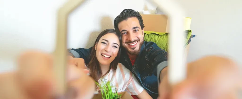 Couple purchase their first home and are celebrating thanks to getting a first-time buyer mortgage with the help of mortgage broker Hayes Finance in London and Beaconsfield.