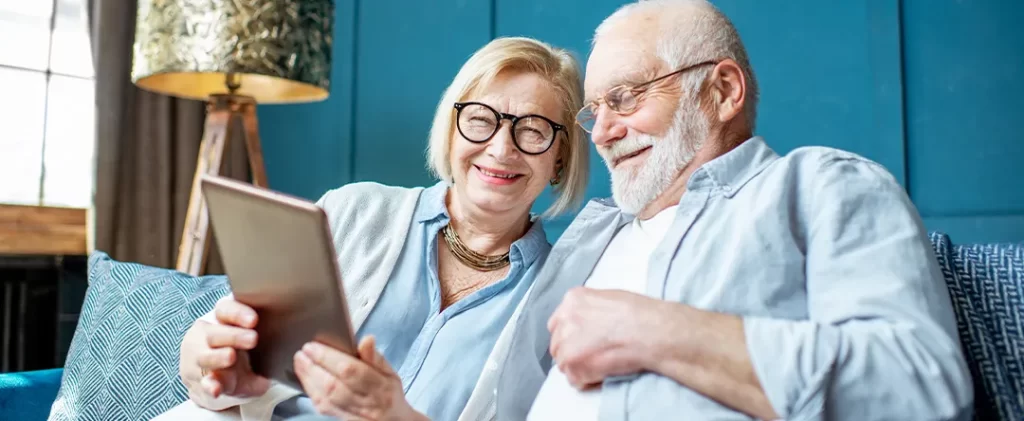 Elderly couple considering lifetime mortgage options with the assistance of their mortgage broker.