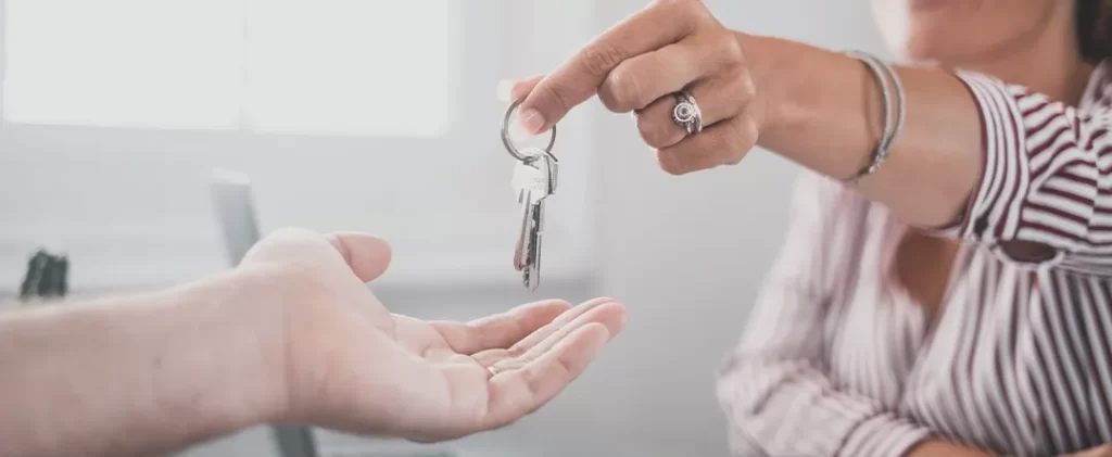 Tenant collecting the keys to a property they are renting. The owner of the property had a buy-to-let mortgage sourced by their mortgage broker to allow them to purchase the property and rent it out to the tenant collecting keys.
